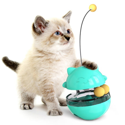 Cat treat dispenser toy with two rolling balls, turquoise bowl and lid, with hanging string and ball.