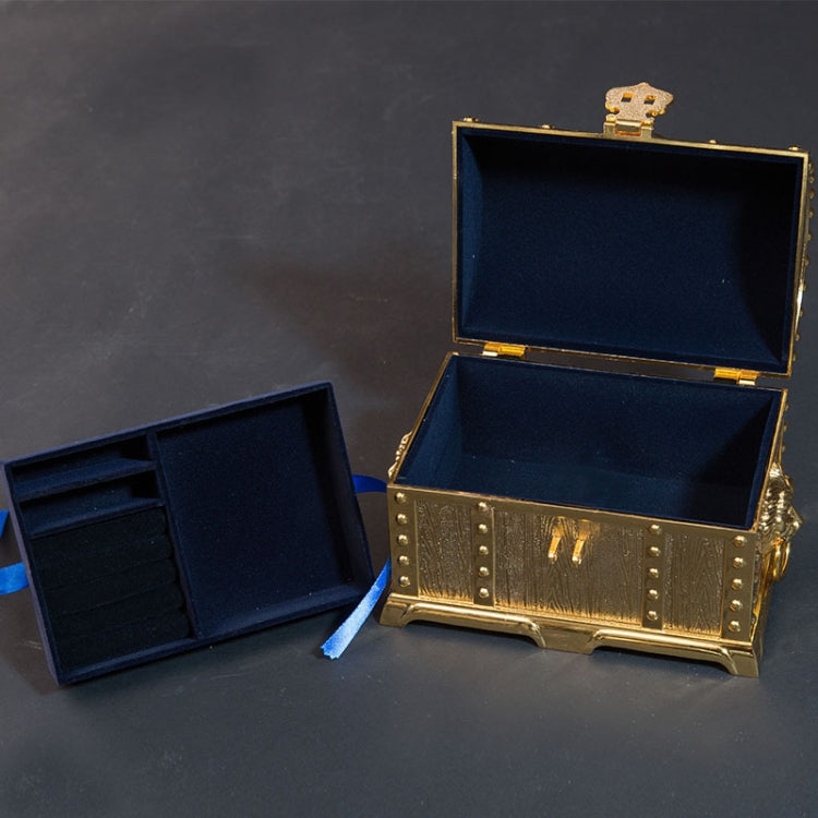 Gold metal jewel box open to reveal dark blue padded compartments