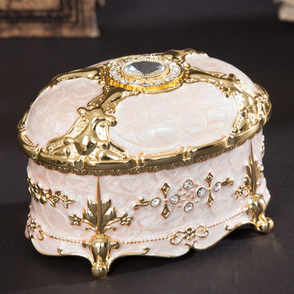 Gold-trim white oval jewelry storage box with diamond-style top and ornate side charms