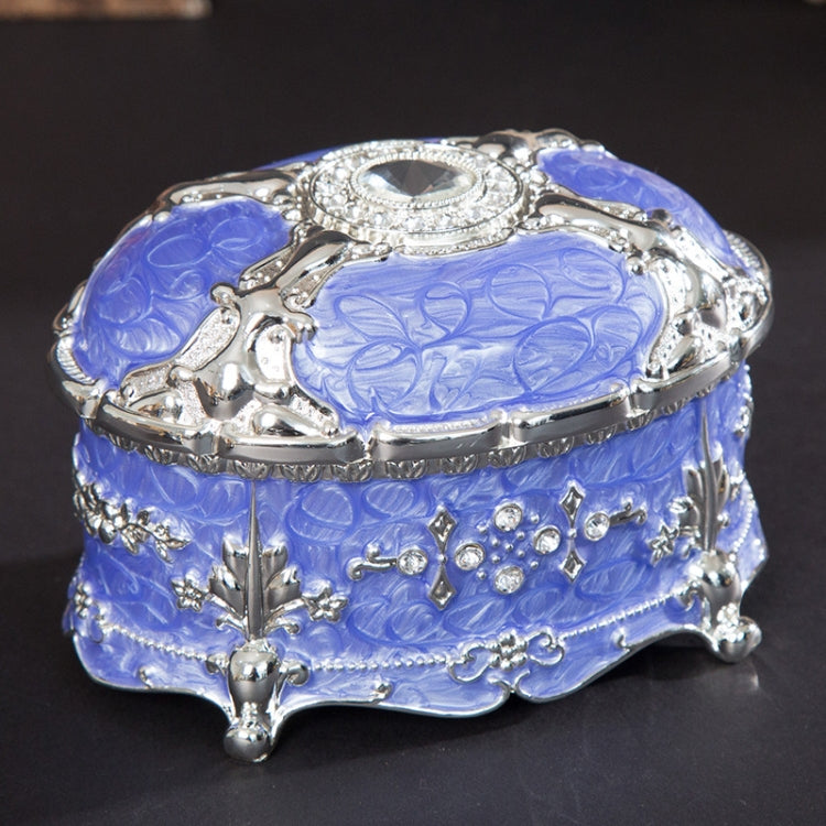 Silver-trim blue oval jewelry storage box with diamond-style top and jeweled front details