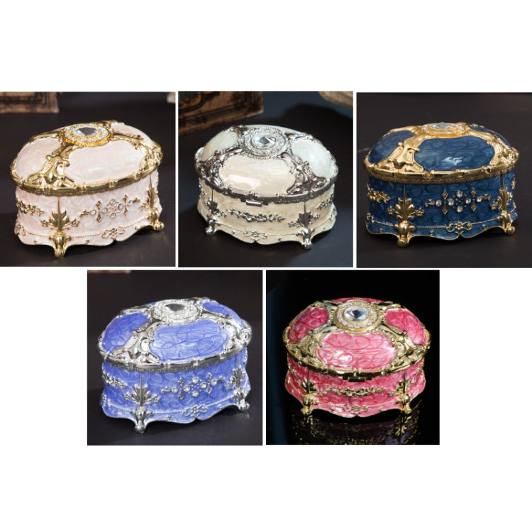 Set of oval jewelry storage boxes in white, silver, blue, and pink colors with diamond-style tops