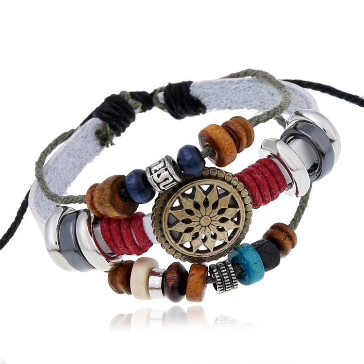 Beaded leather bracelet with circular bronze-gold charm, blue red beads, stacked metal rings