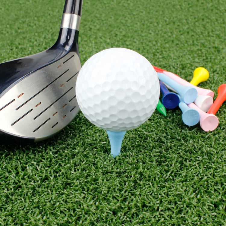 Golf ball on blue tee with colorful wooden ball holders near a club head