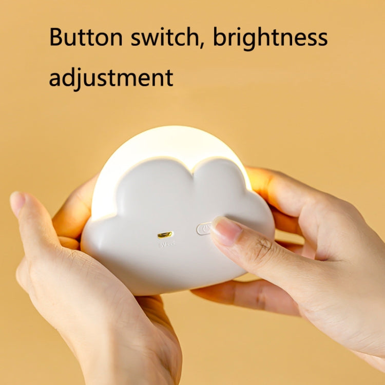 White cloud-shaped USB night light held in hands