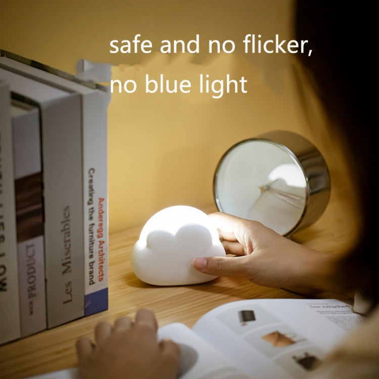 Cloud-shaped USB night light resting on a bedside surface