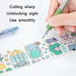 Hand holding green utility knife pen, blade tip cutting printed craft paper