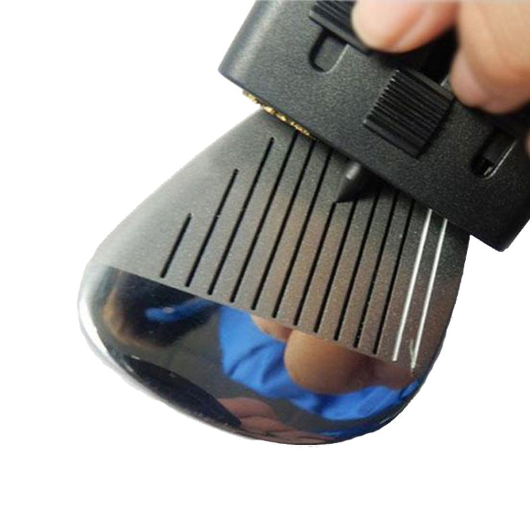 Hand holding retractable brush cleaning golf iron grooves with bristle head