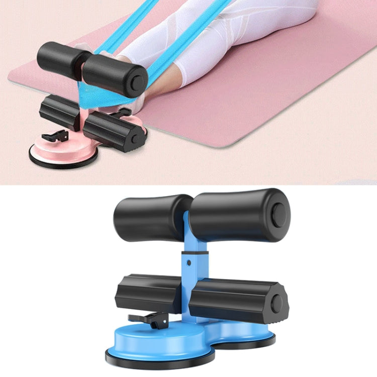 Black sit-up aid with blue suction base, padded rollers, and ankle supports