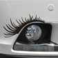 Black eyelash eyebrow headlight sticker on white car headlight corner.