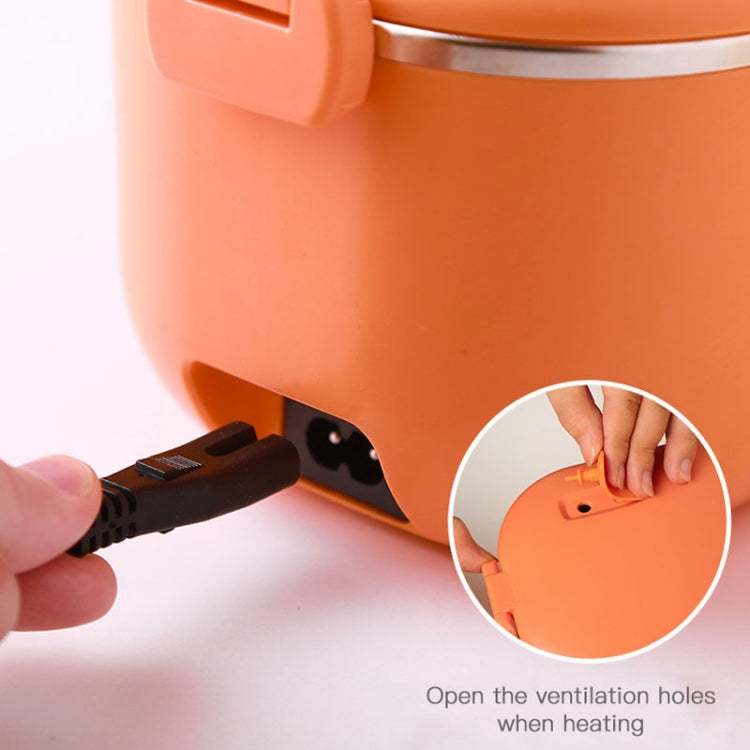 Orange heating lunch box underside with power cord plugged in and ventilation holes