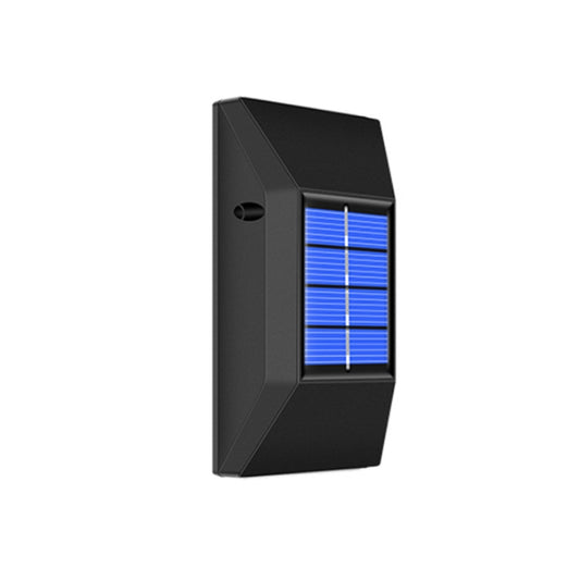 Black rectangular solar wall light with glowing blue LED grid in front window
