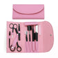 Pink eyebrow trimming tool set in open roll pouch with scissors, combs, and trimmers