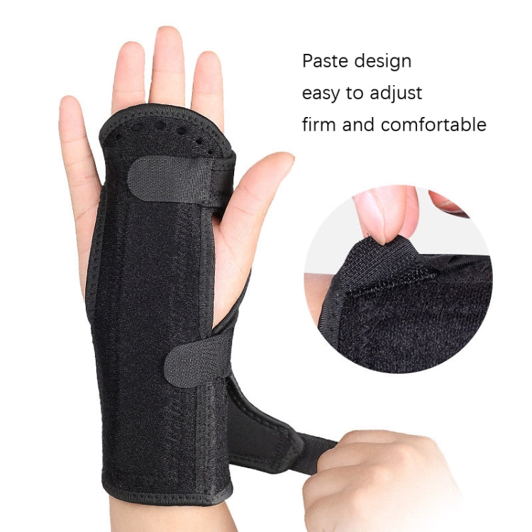 Black padded wrist brace on an open hand with adjustable fastening strap