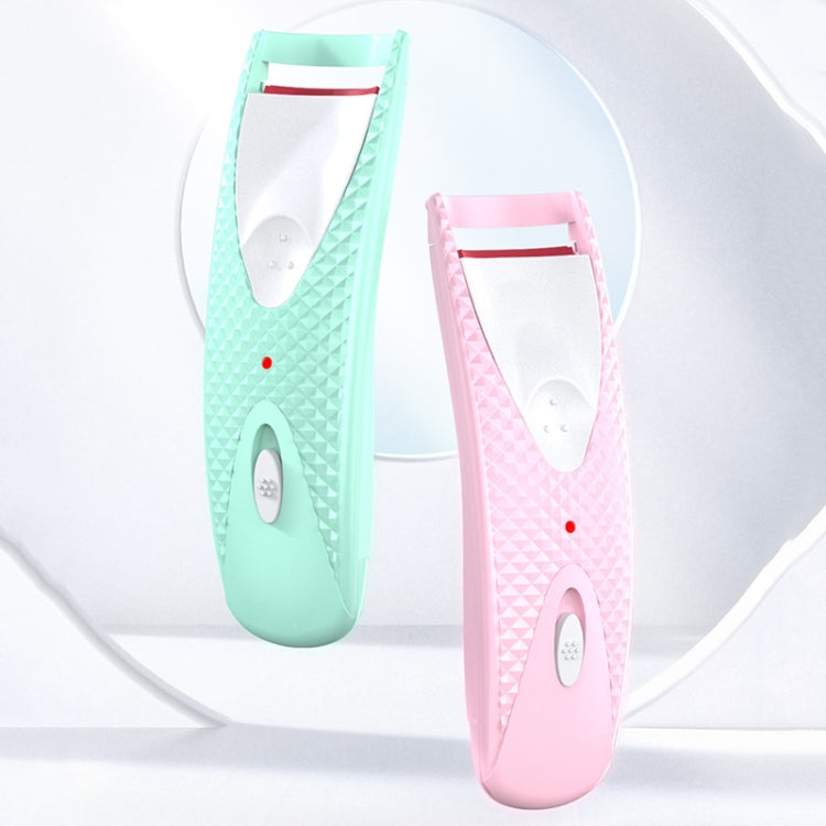 Pair of heated eyelash curlers, mint and pink, with open oval heating plate