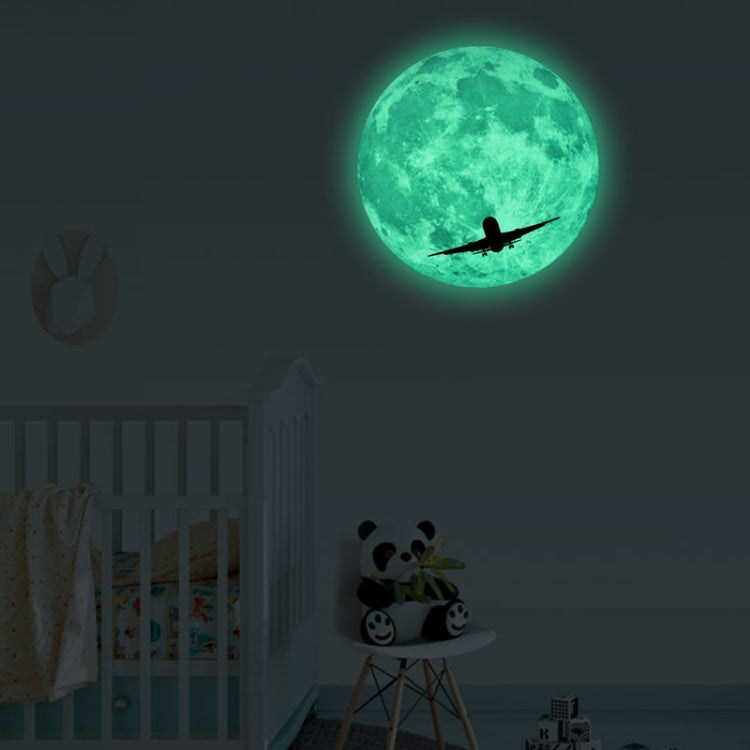 Glowing green moon wall sticker with airplane silhouette flying across the moon
