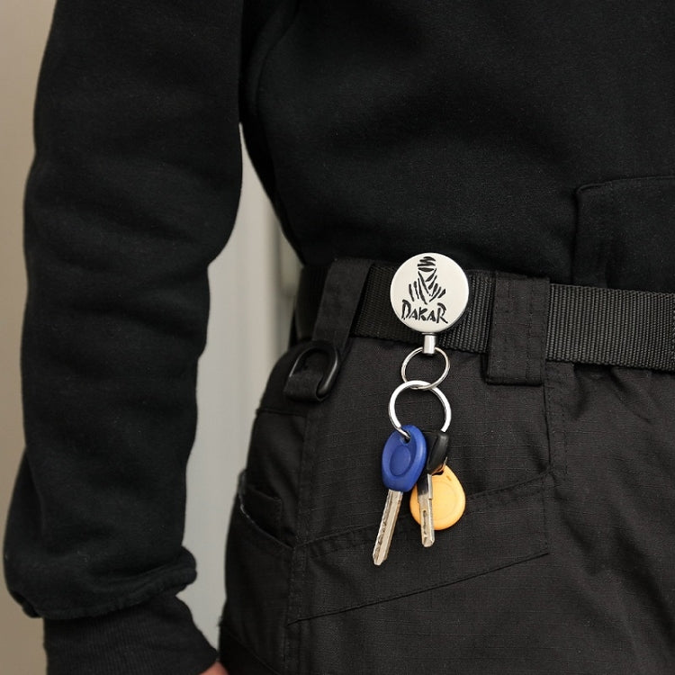 Retractable key ring on black belt with round silver disc and metal key loop