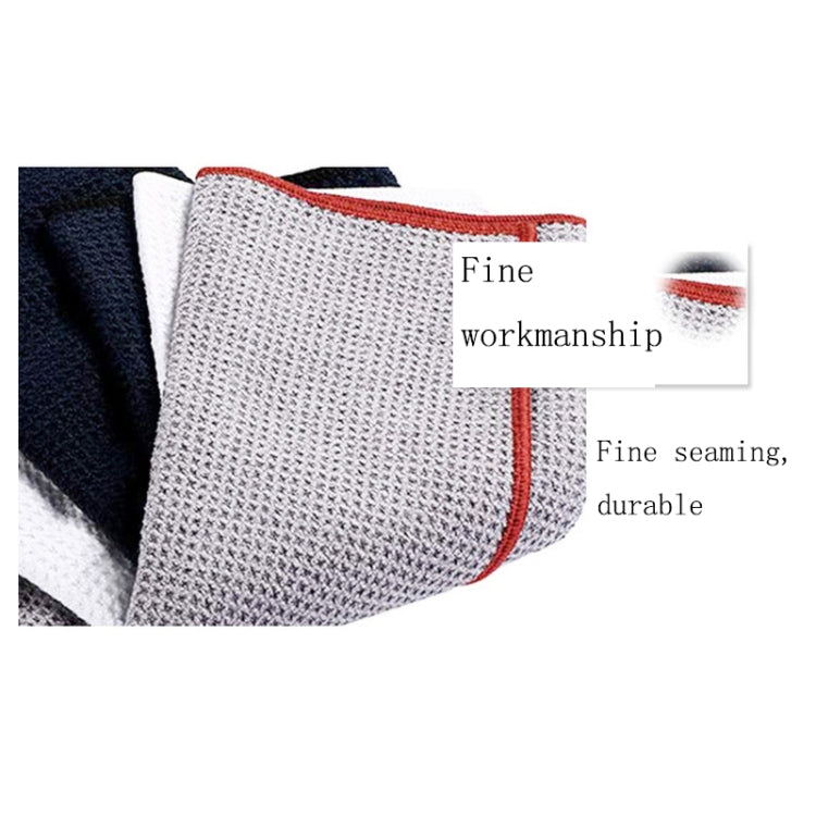 Close-up of white golf towel with red edge trim and hook loop