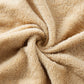 Beige coral fleece towel close-up with soft plush pile texture