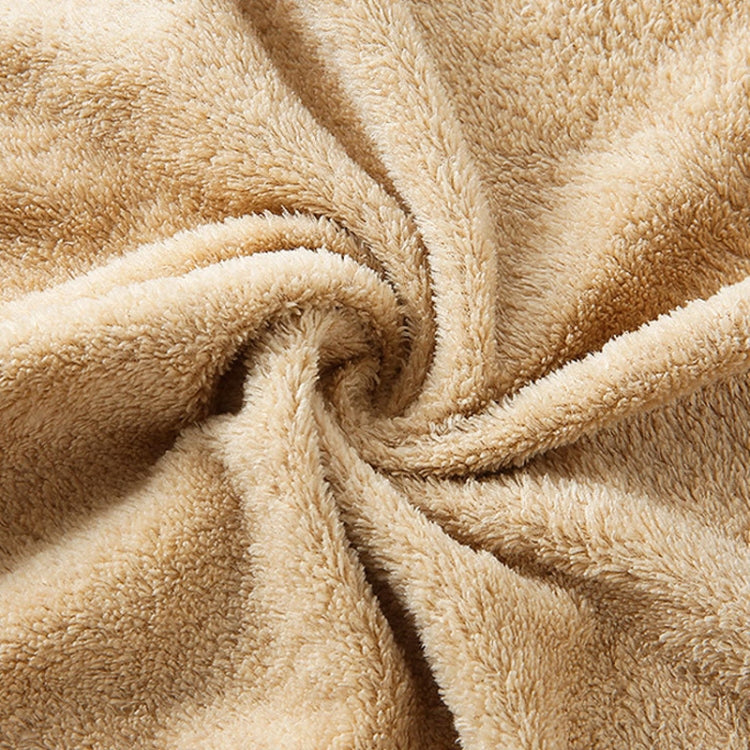 Beige coral fleece towel close-up with soft plush pile texture