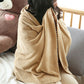 Beige coral fleece towel wrap for lounging, draped over shoulders