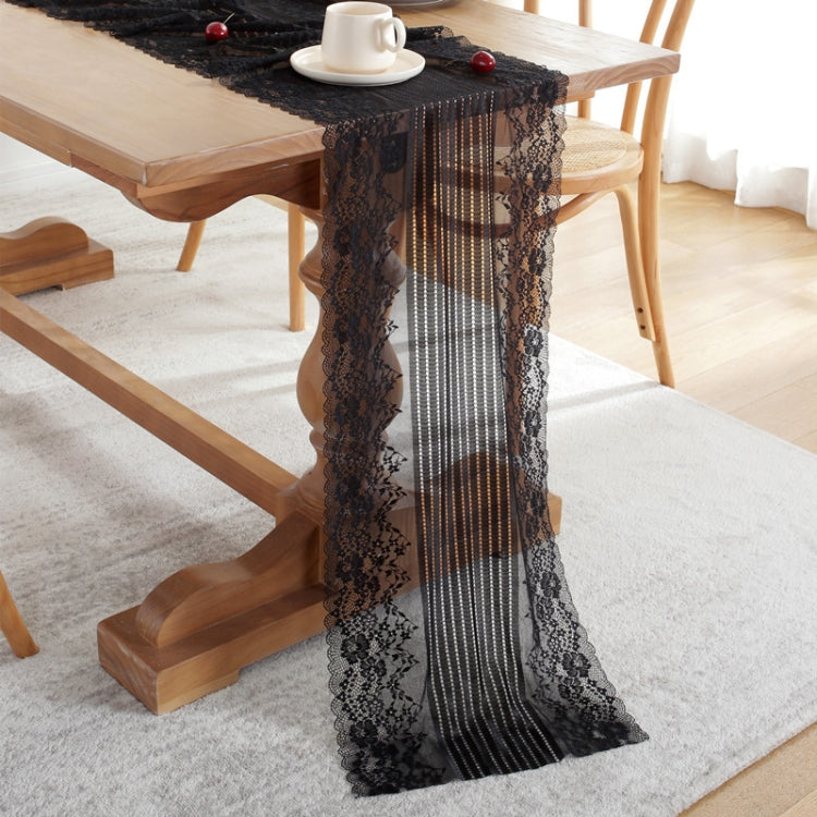 Black lace table runner with scalloped edges and vertical striped center panel