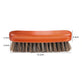 Orange wooden shoe dust brush with dense dark bristles and rounded top