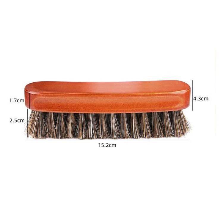 Orange wooden shoe dust brush with dense dark bristles and rounded top