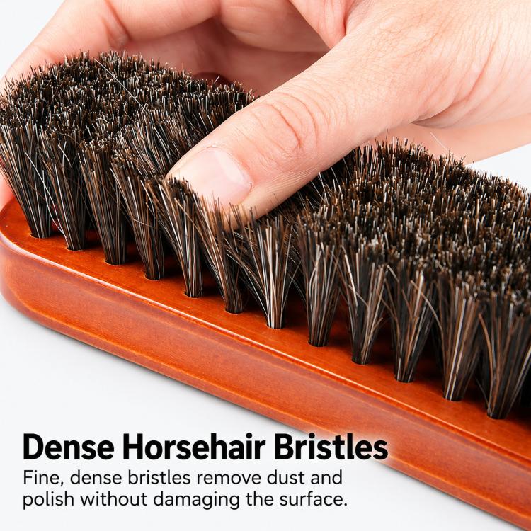 Close-up: hands pressing dense bristles of a wooden shoe dust brush on the base