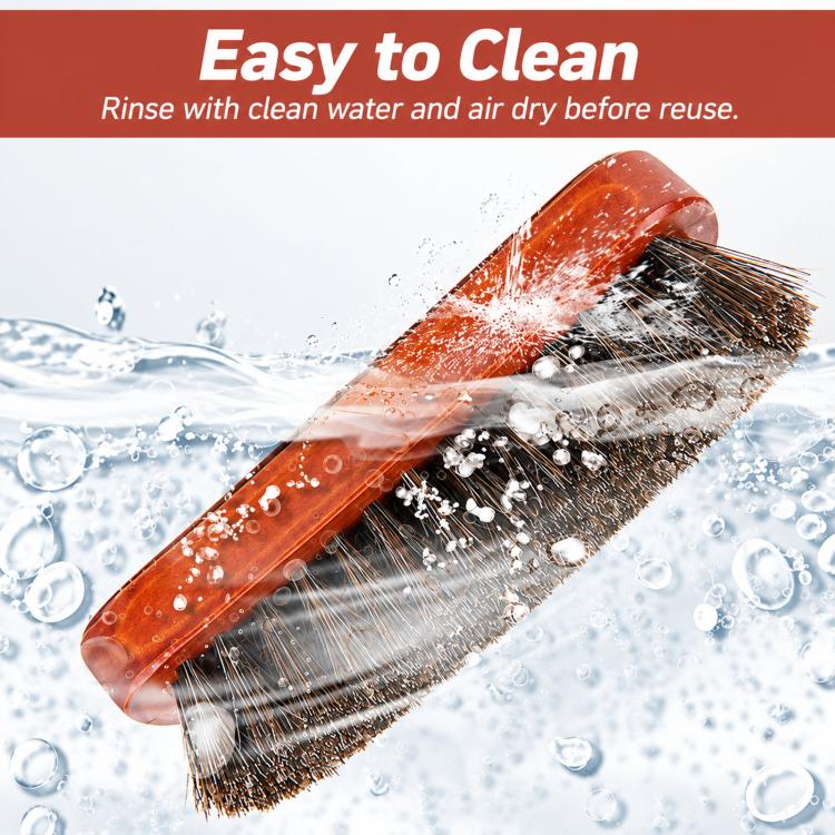 Shoe cleaning brush with wooden handle and dense bristles, covered in water droplets