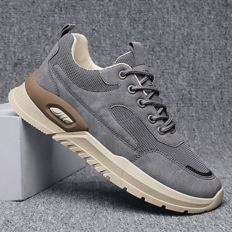 Gray height-increasing running shoes with lace-up front and visible air-cushion detail