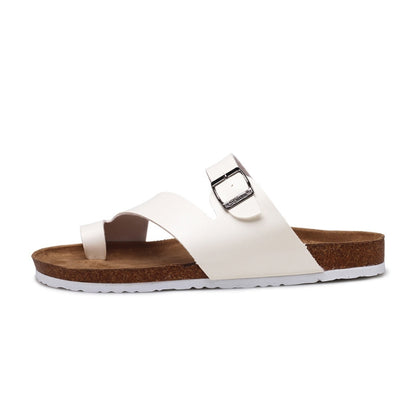 White cork slide sandals with adjustable metal buckle and cushioned footbed