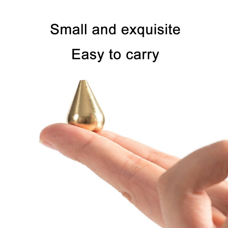 Gold incense insert plate held in hand with small cone opening