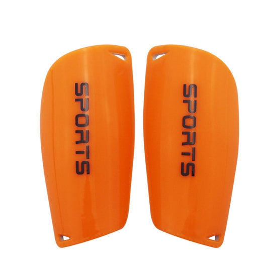 Pair of orange football shin guards with raised edges and SPORT lettering