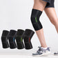 Set of black stretch knit knee pads with gray panels and neon green, worn on legs.