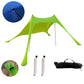 Green beach sunshade tent with mesh canopy, stakes, and carry bag