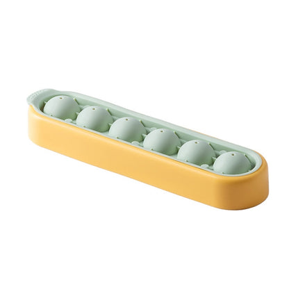 Silicone ice cube mold tray, yellow exterior with mint-green cube cavities