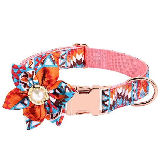 Orange patterned dog collar with adjustable metal buckle, flower bow, and round charm