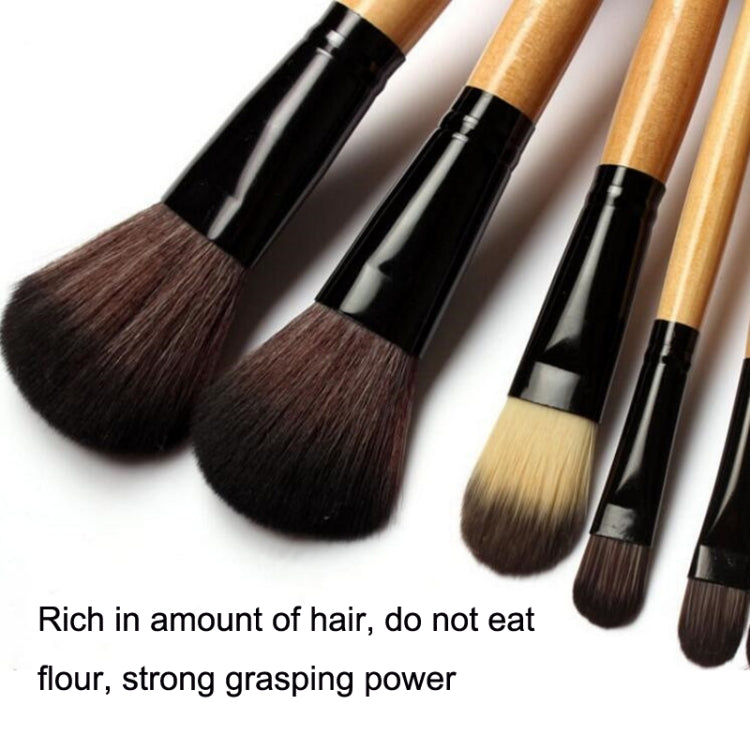 Makeup brush set close-up with dark bristles on black and wood handles