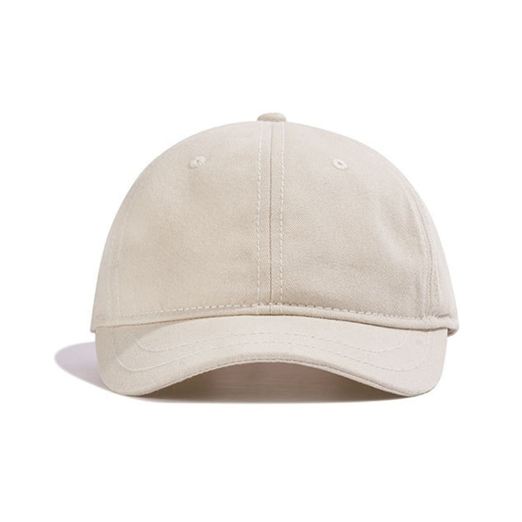 Beige baseball cap with short curved brim and stitched crown panels