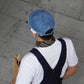 Denim blue denim cap viewed from behind with label patch and short brim