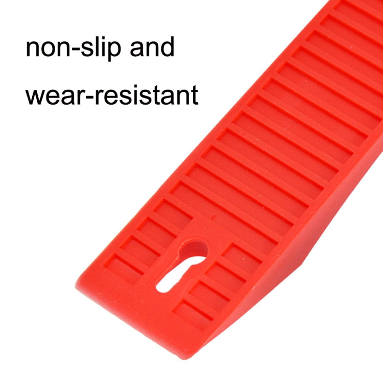 Red barbell plate protective gasket detail: non-slip ridges and oval slot