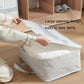 Gray geometric-pattern storage bag opened wide with hands lifting the top flap