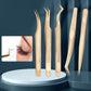 Set of gold eyelash extension tweezers with varied curved tips and patterned handles