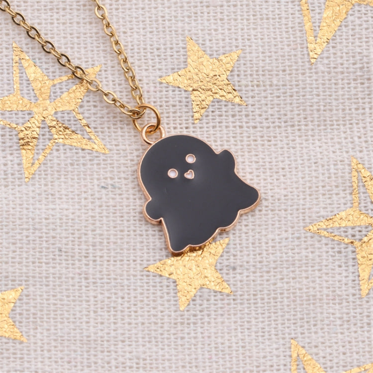Black ghost charm pendant on gold-tone chain with small heart eyes detail.