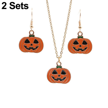 Gold-tone necklace with three orange pumpkin jack-o’-lantern pendants and green loops