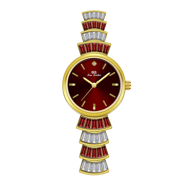 Ladies wrist watch with red dial, gold-tone case, and red diamond-like bezel accents