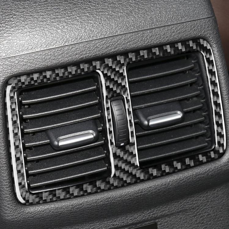 Installed carbon-fiber air outlet trim with two vents, center tab, and divider
