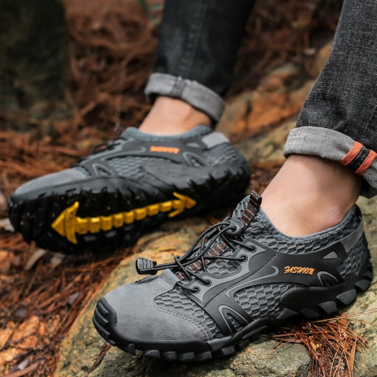 Gray hiking sandals with laced strap, rugged sole with yellow tread