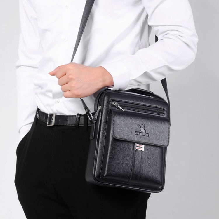 Men's black messenger bag worn on shoulder with front flap, dual zip compartments, side strap
