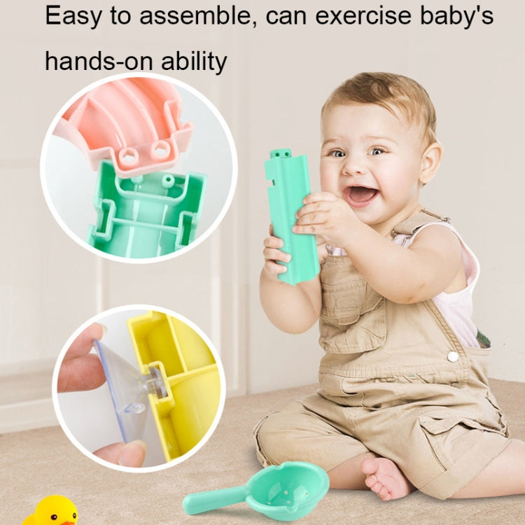Bath slide building block toy held by smiling child with teal launcher piece